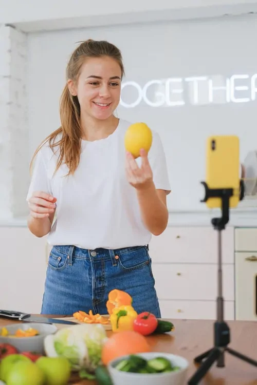 A creator records a video for her audience.